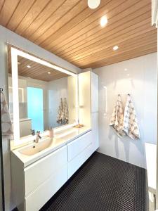 a bathroom with a sink and a mirror at 46m2 Studio in Rovaniemi