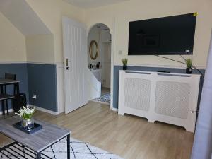 a living room with a flat screen tv on a wall at Home in Beckton. Docklands. London City Airport. in London