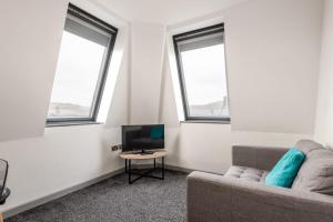 Modern 1 Bed Budget Apartment in Central Halifax في هاليفاكس: غرفة معيشة مع أريكة وتلفزيون