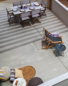 an overhead view of a patio with a table and chairs at Tinos Treasures Apart-Hotel in Istérnia