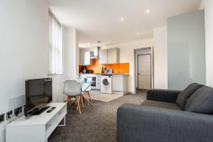 a living room with a couch and a kitchen at Contemporary 1 Bed Budget Flat in Central Halifax in Halifax