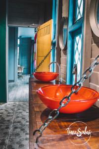 two red sinks on a counter in a room at Time Sabai 134 in Bangkok