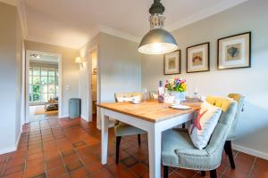 a dining room with a table and chairs at Haus Alster Whg 1 in Keitum