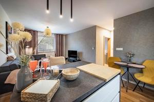 a kitchen and living room with a table and chairs at Apartments Centrum Hviezdoslav in Poprad