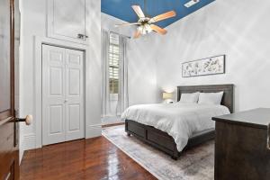 a bedroom with a bed and a ceiling fan at Bywater Bungalow in New Orleans