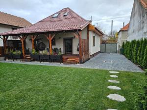 a house with a gazebo in a yard at Arbor Inn in Braşov