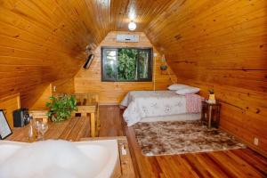a bedroom with a bed in a wooden cabin at Chalé lua cheia in Flores da Cunha