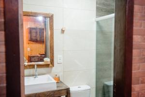 a bathroom with a sink and a mirror at Chalé lua cheia in Flores da Cunha