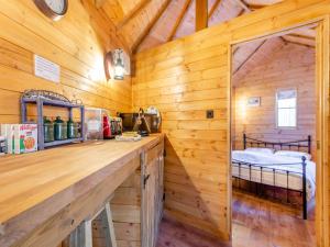 a cabin with a bed in a room with wooden walls at Beavers- Uk45706 in Cambridge