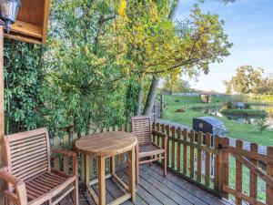 a wooden deck with two chairs and a table and a grill at Beavers- Uk45706 in Cambridge