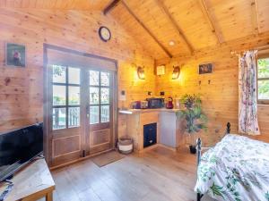 a bedroom with wooden walls and a wooden floor at Beavers- Uk45706 in Cambridge