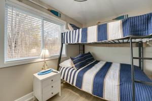 a bedroom with two bunk beds and a window at Updated Algonac Home - Walk to St Clair River! in Algonac