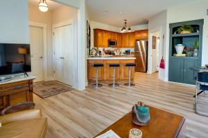 a large kitchen with wooden floors and blue cabinets at Charming Granville Home with Porch - Walk Downtown! in Granville