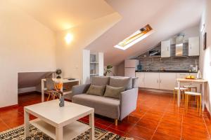 a living room with a couch and a table at Ribeiro´s House, New apartment with amazing sunsets in Arco da Calheta