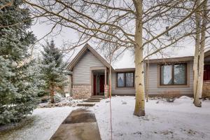 a house with snow in front of it at East Village Duplex at Copper Mountain Resort! in Frisco