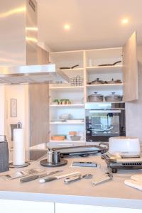 a kitchen with a counter with utensils on it at Premium Zuhause - Seeblick, Balkon, Pool & Seepromonade in Langscheid