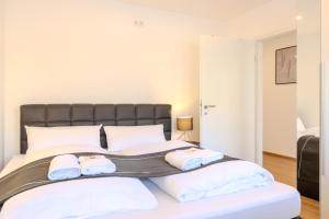 a bedroom with a large bed with two towels on it at Premium Zuhause - Seeblick, Balkon & Seepromenade in Langscheid