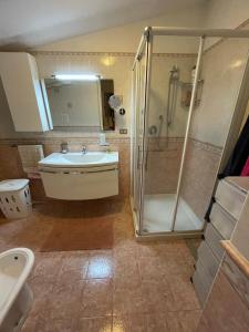 a bathroom with a shower and a tub and a sink at Villa dei Gelsi in Leporano Marina