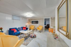 a living room with a blue couch and orange chairs at 1 Mi to Downtown Salem Vacation Rental! in Salem