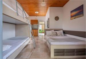 a bedroom with two bunk beds and a staircase at Studios Vagelis in Kalamitsi