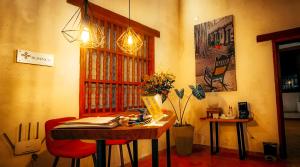 Habitación con mesa y ventana con libros. en Hotel Boutique Casa Gerar, en Mompox
