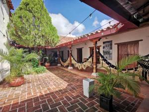 a courtyard of a house with potted plants at Hotel Boutique Casa Gerar in Mompos