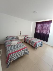 מיטה או מיטות בחדר ב-Casa Villa Rumipal