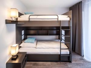 a bedroom with two bunk beds and a desk at Mood contemporary living in Mannheim +22 photos