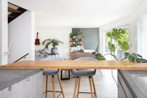 a kitchen with a wooden counter top and some plants at Entire modern villa with outdoor swimming pool! in Treyvaux