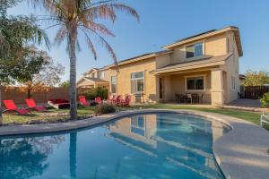 a swimming pool in front of a house at Paradise Retreat Heated Privat Pool BBQ in Casa Grande