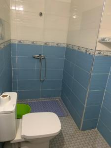 a bathroom with a toilet and a shower at EL MAR BEACH in Moulay Bousselham