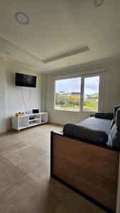 a bedroom with a bed and a flat screen tv at Comarca Fueguina in Ushuaia