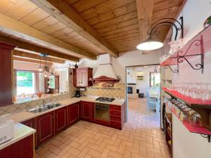 a kitchen with a sink and a stove top oven at Il Noceto in Monte San Giusto