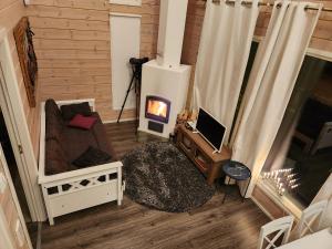 sala de estar con sofá y chimenea en Peuhuntie As 15 en Oulu