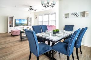 a dining room with a table and blue chairs at Mardi Gras Magic Getaway in Baton Rouge - BC1019 in Baton Rouge