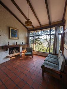 a living room with a bed and a fireplace at Rustic lodge Samaipata in Samaipata