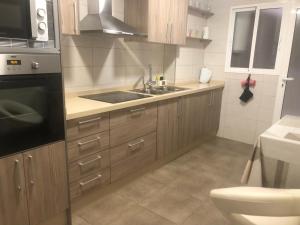 a small kitchen with a sink and a toilet at Casa Bia Plus in Elche