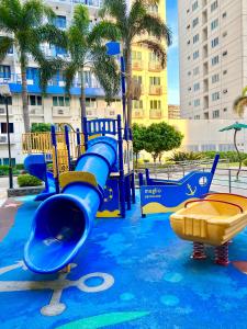 a water park with a blue slide and a slide at Sea Residences: Eyal’s Suite Condotel near MOA/Mall of Asia in Manila +7 photos