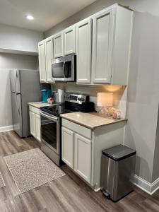 a kitchen with white cabinets and a stainless steel refrigerator at 2 BR 1 BA apartment in Newnan
