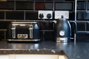 a toaster and tea kettle sitting on a counter at Luxury Hideaway, City Centre,Parking,Netflix Sleeps 3 in Coventry