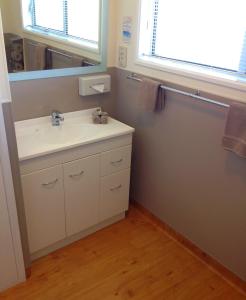 a bathroom with a sink and a mirror at Aalton Motel in Christchurch