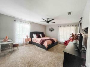 a bedroom with a bed and a ceiling fan at Spacious Austin Retreat for Families & Groups in Manchaca