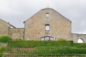 ein Backsteingebäude mit einem Kreuz darüber in der Unterkunft La Ferme du Colombier in Hamois