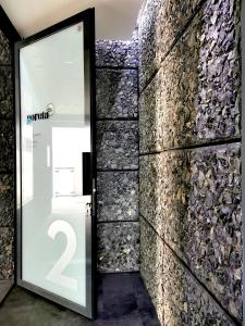 a door in a room with a stone wall at Goreta032 Luxury Apartment 2 in Vukovar +21 photos