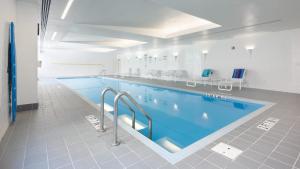 a large swimming pool in a building at Kendall Square 1br w gym wd concierge nr MIT BOS-838 in Boston