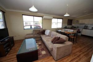 a living room with a couch and a table at Beach Unit 7 at Hat Head in Hat Head