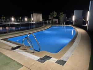 a swimming pool at night in a building at TECNOCORDOBA II aparcamiento privado gratuito y piscina in Córdoba +6 photos