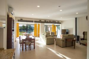 a living room with a table and a dining room at Cortijo San Antonio de Trejo in Setenil