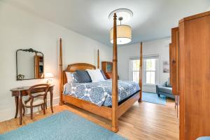 a bedroom with a bed and a table and a chair at Spacious Naples Vacation Rental with Private Hot Tub in Naples