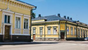 two yellow buildings next to each other on a street at Hamina Bastion Apartments in Hamina